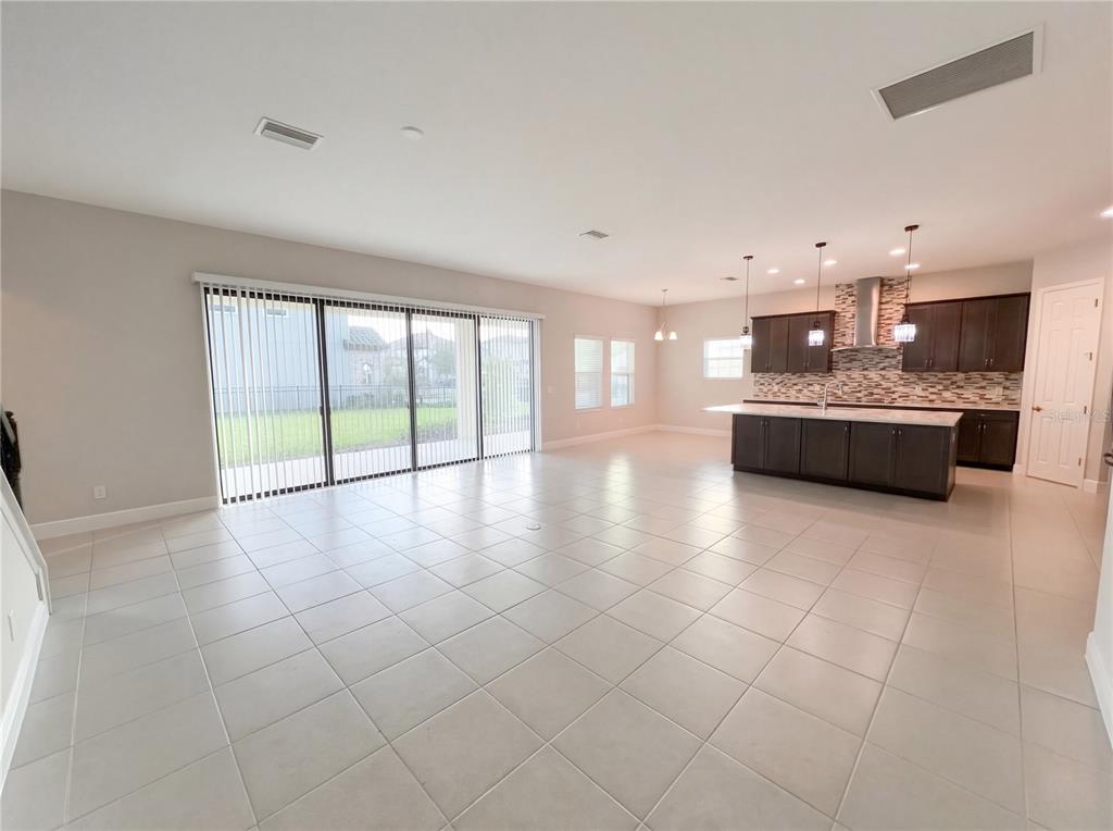 11277 Rustic Timber Loop San Antonio, FL 33576 - Photo 37 of 55 a large white kitchen with a large counter top and stainless steel appliances
