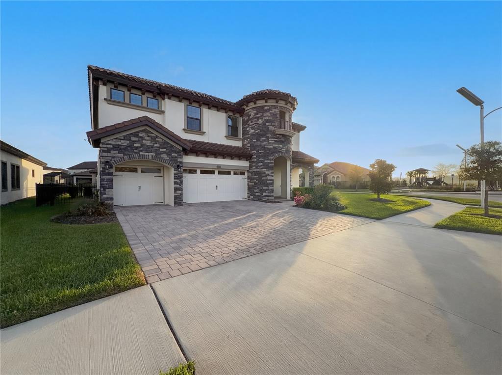 11277 Rustic Timber Loop San Antonio, FL 33576 - Photo 39 of 55 a front view of a house with a yard and garage