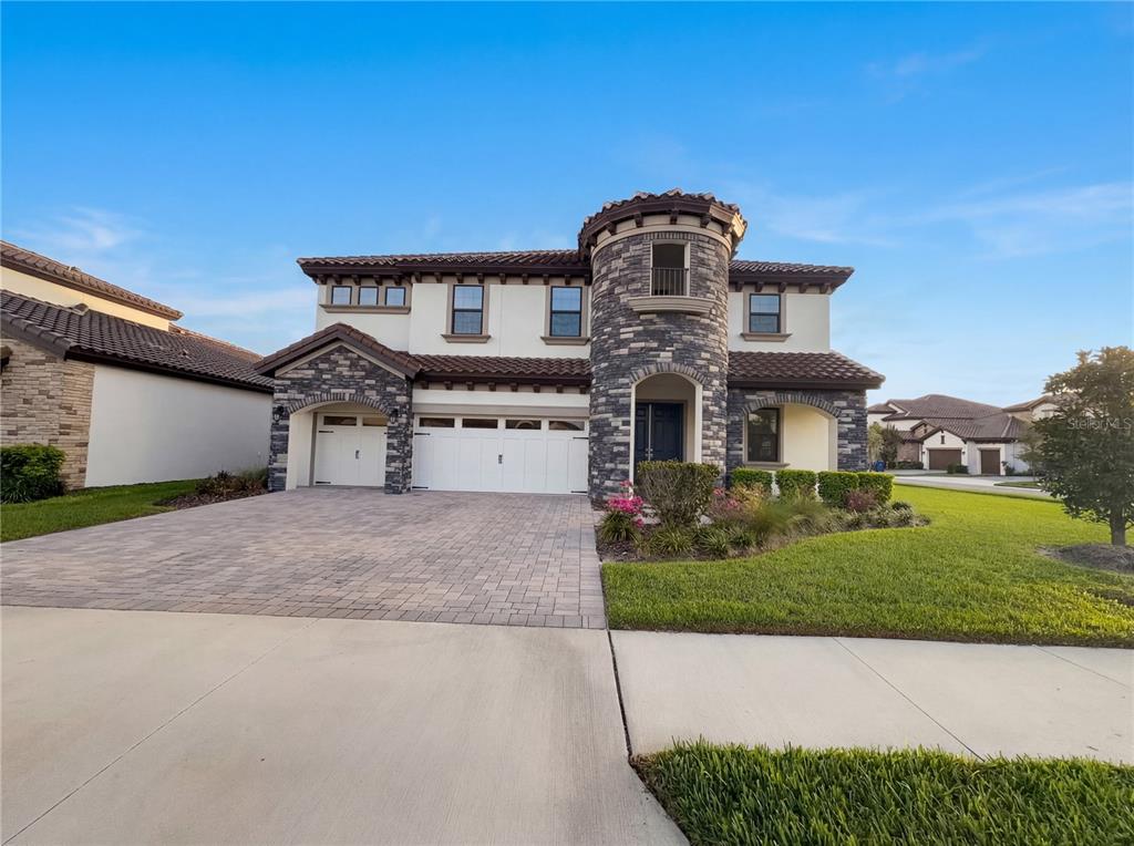 11277 Rustic Timber Loop San Antonio, FL 33576 - Photo 40 of 55 a front view of a house with a yard and garage