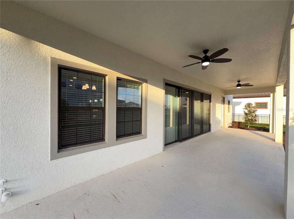 11277 Rustic Timber Loop San Antonio, FL 33576 - Photo 6 of 55 a view of an empty room with a fireplace and a large window
