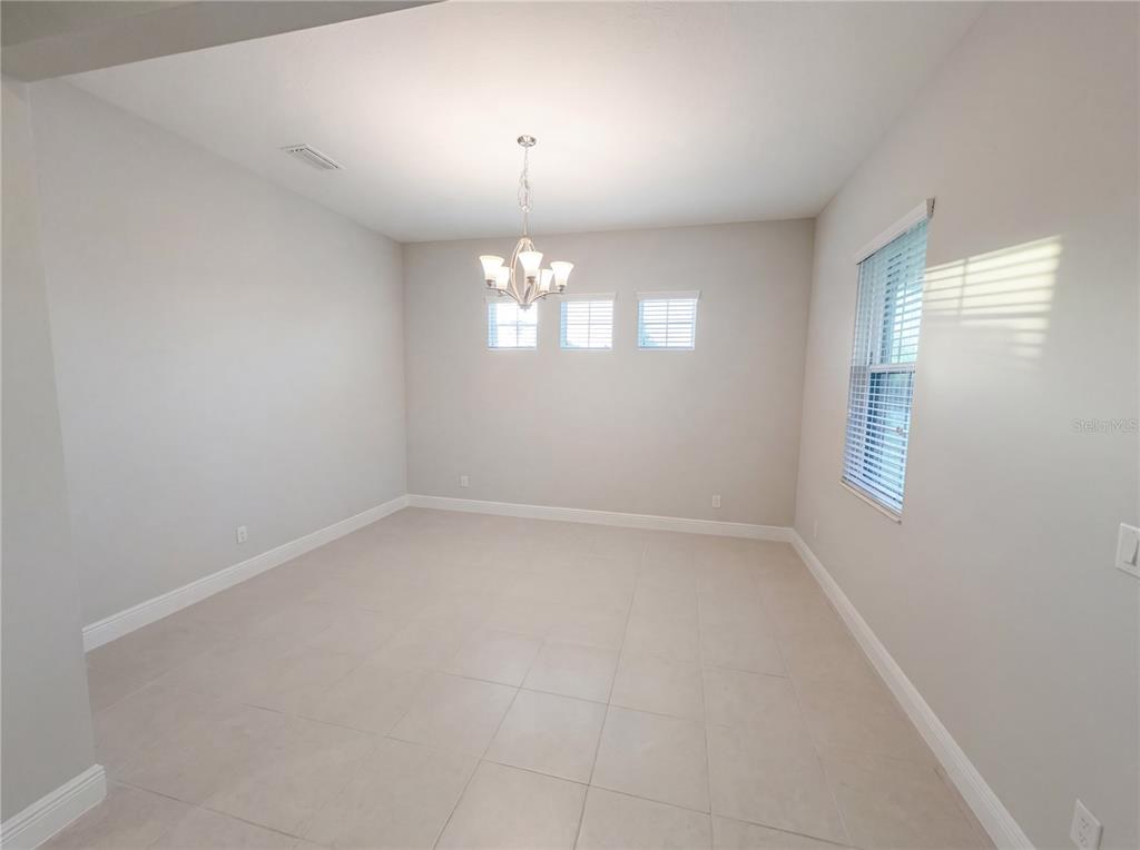 11277 Rustic Timber Loop San Antonio, FL 33576 - Photo 7 of 55 wooden floor in an empty room with a window