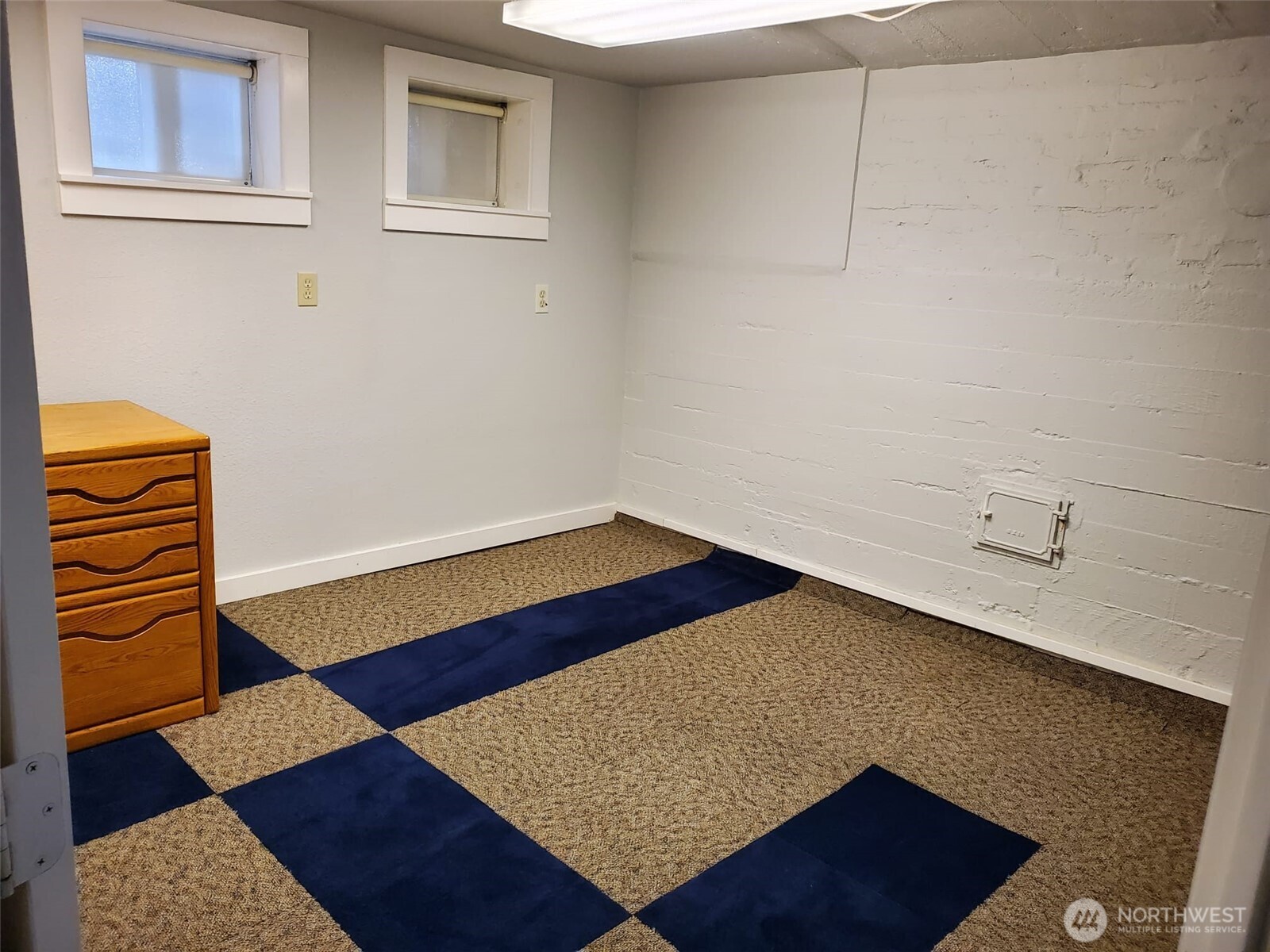 2424 South Graham Street Seattle, WA 98108 - Photo 18 of 23 a view of an empty room with a rug and wooden floor