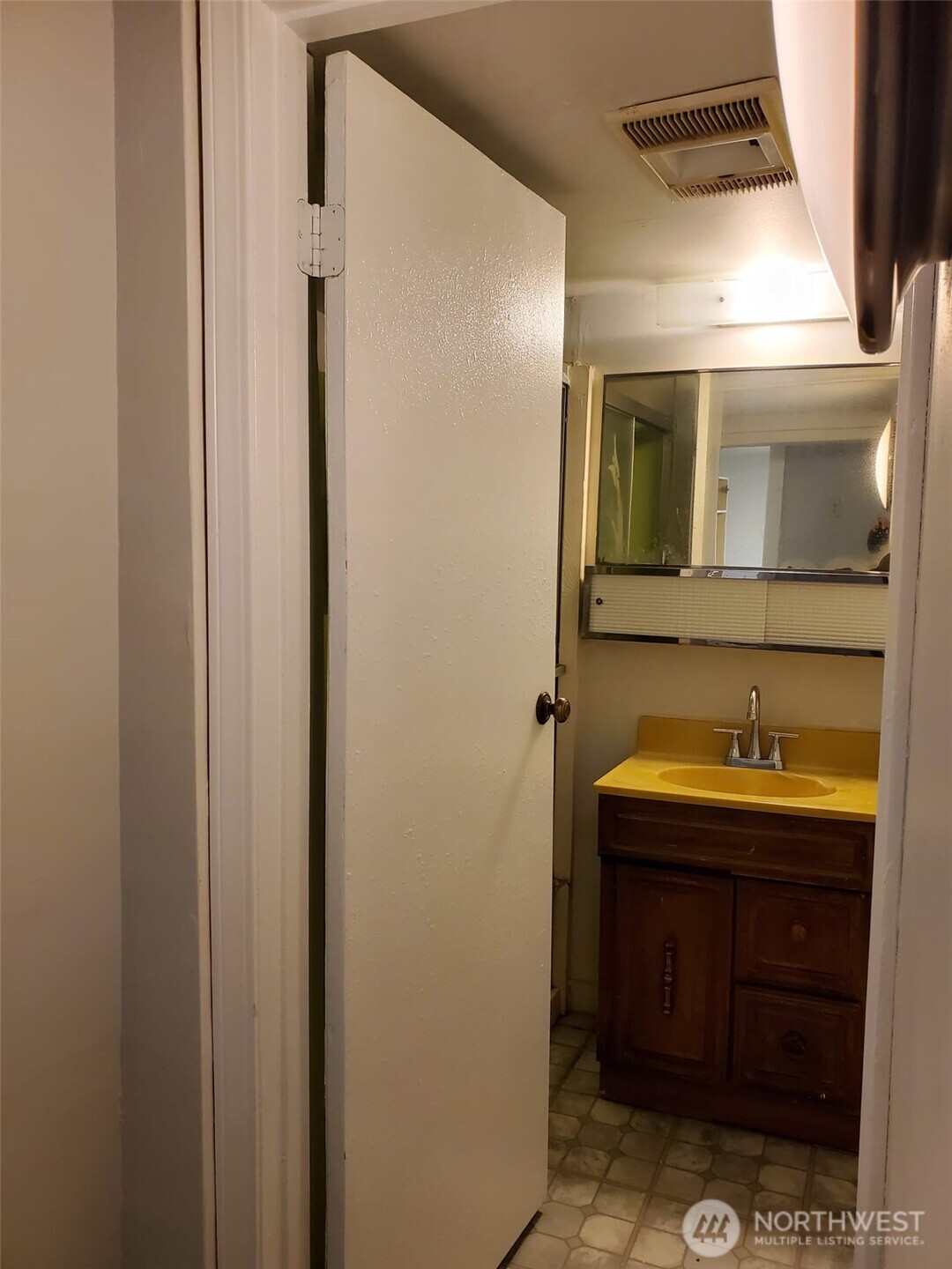 2424 South Graham Street Seattle, WA 98108 - Photo 20 of 23 a bathroom with a sink and a mirror