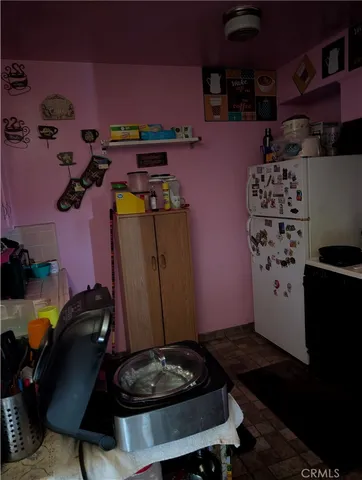a kitchen with a refrigerator and a stove
