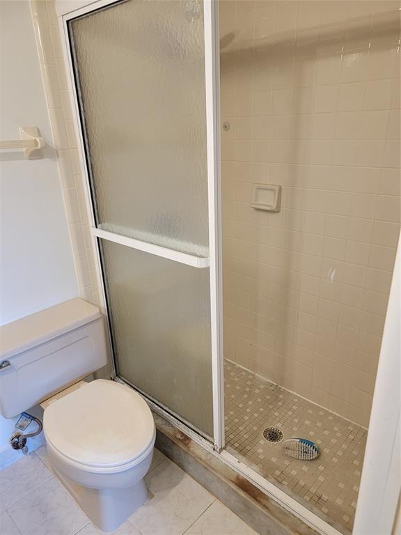 1800 Northeast 39th Court, Unit 1001 Pompano Beach, FL 33064 - Photo 14 of 39 a bathroom with a toilet and a shower