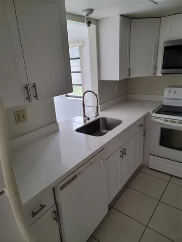 a kitchen with a sink and cabinets