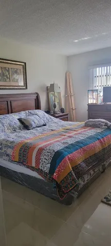 a living room with furniture a flat screen tv and a window