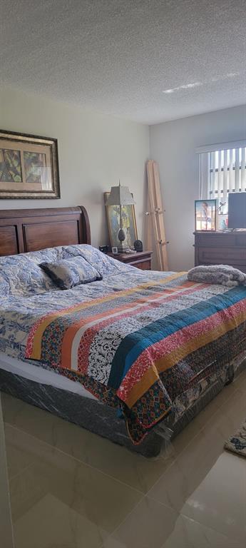 1800 Northeast 39th Court, Unit 1001 Pompano Beach, FL 33064 - Photo 23 of 39 a bedroom with bed and window