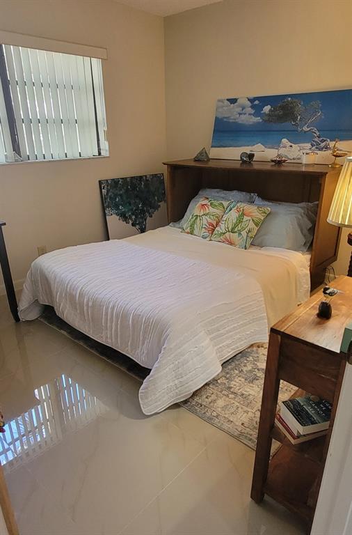 1800 Northeast 39th Court, Unit 1001 Pompano Beach, FL 33064 - Photo 33 of 39 a bedroom with a bed and window