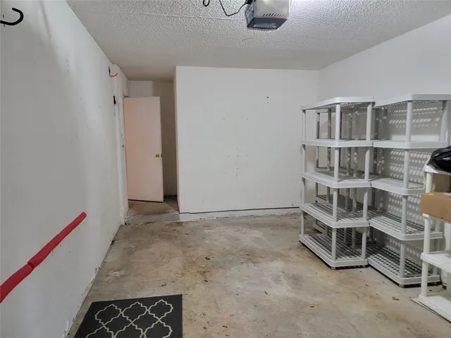 a view of an empty room with empty shelves