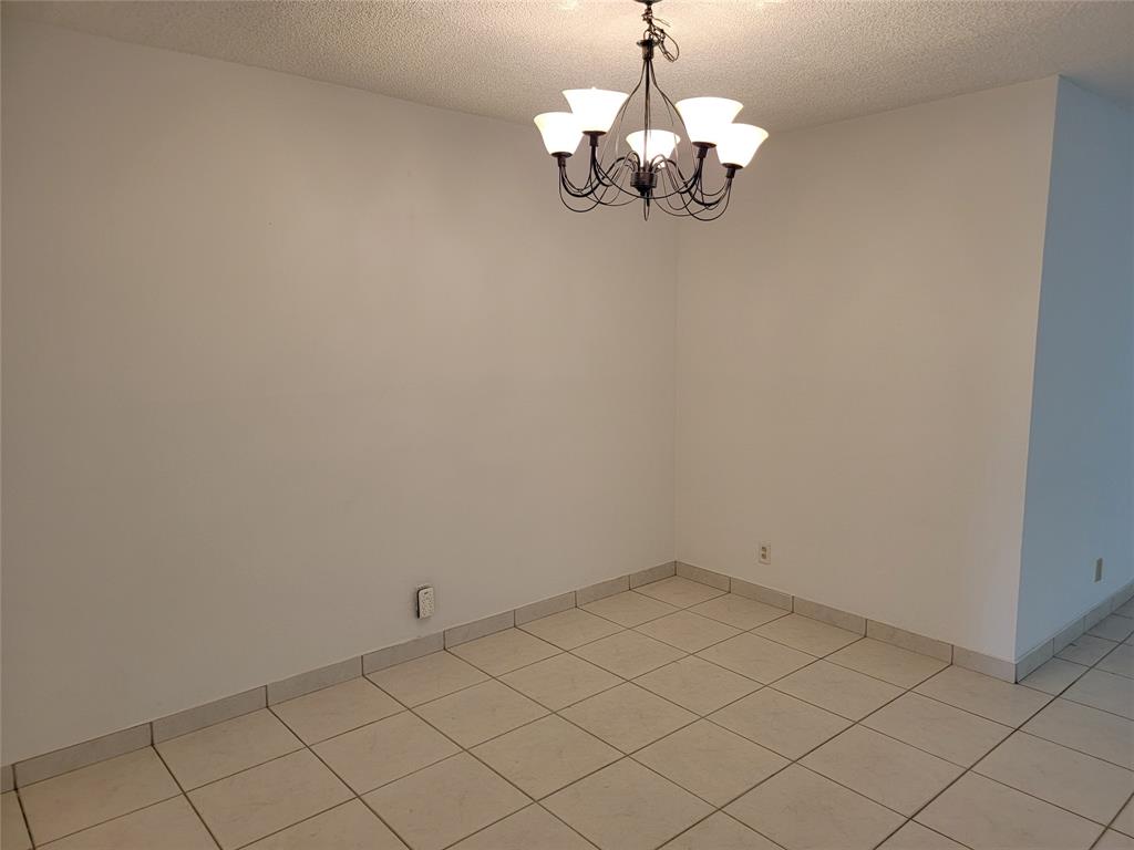 1800 Northeast 39th Court, Unit 1001 Pompano Beach, FL 33064 - Photo 9 of 39 a view of a chandelier fan and hardwood floor