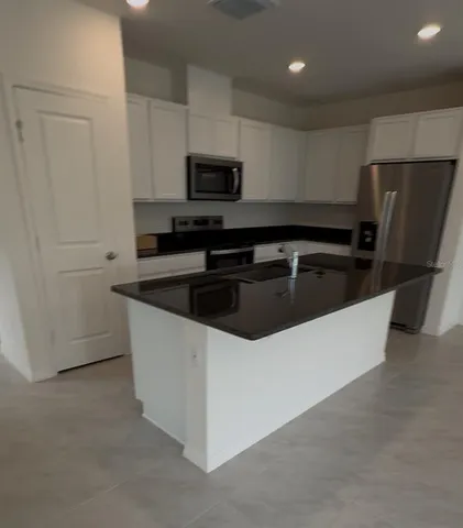 a kitchen that has a sink and a microwave