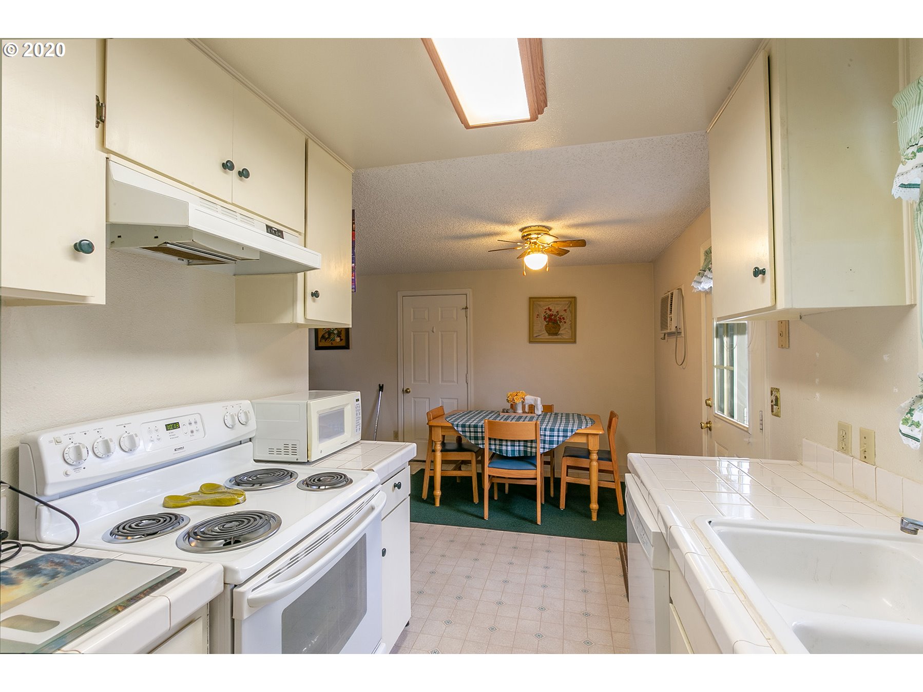 220 South 52nd Place Springfield, OR 97478 - Photo 8 of 28 a kitchen with a sink and a stove top oven