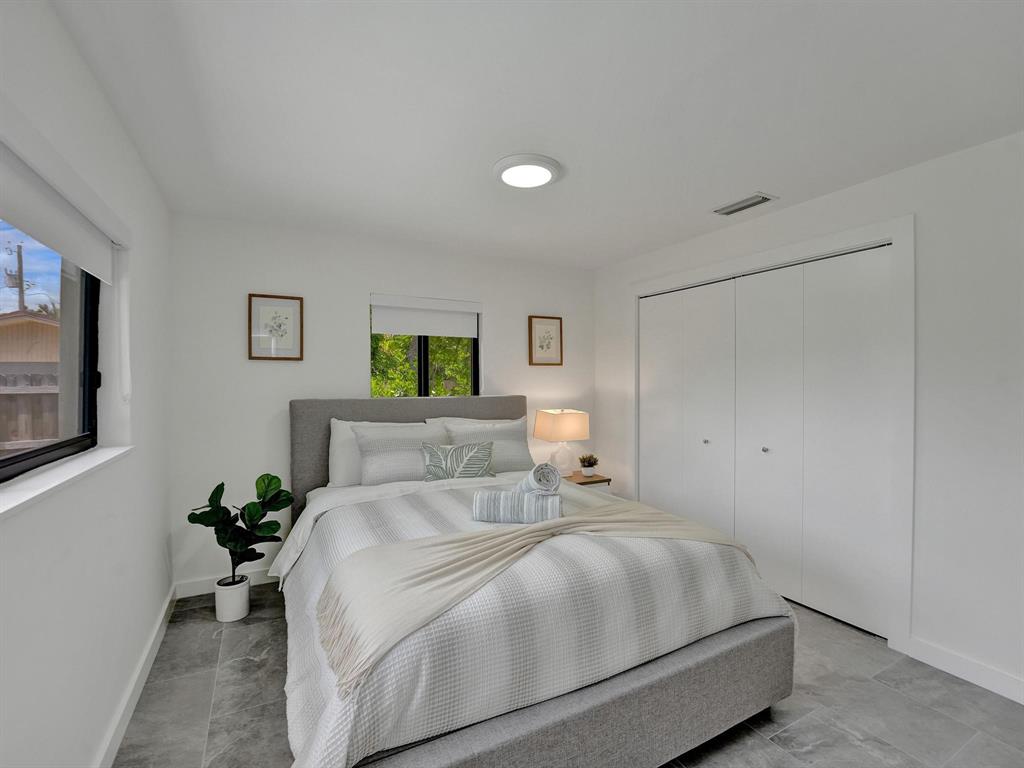 260 Northwest 36th Street Boca Raton, FL 33431 - Photo 11 of 35 a bedroom with a bed and a potted plant