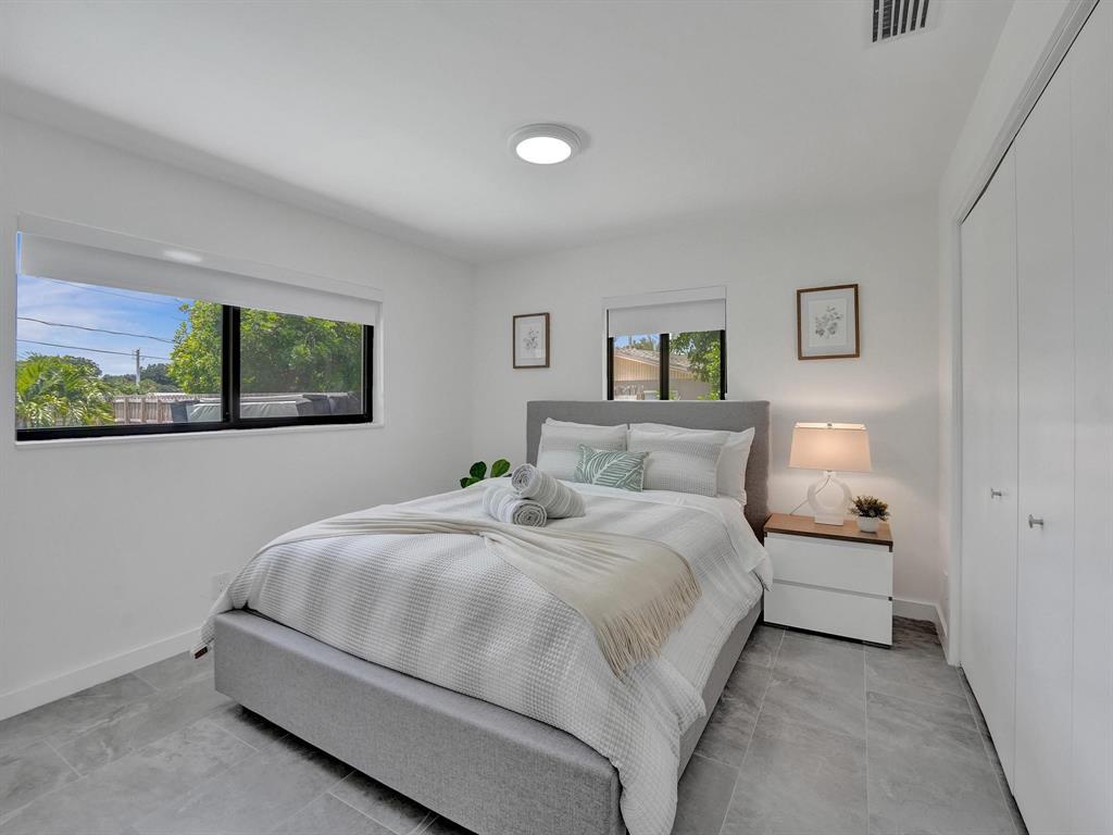 260 Northwest 36th Street Boca Raton, FL 33431 - Photo 13 of 35 a bedroom with a bed and a large window