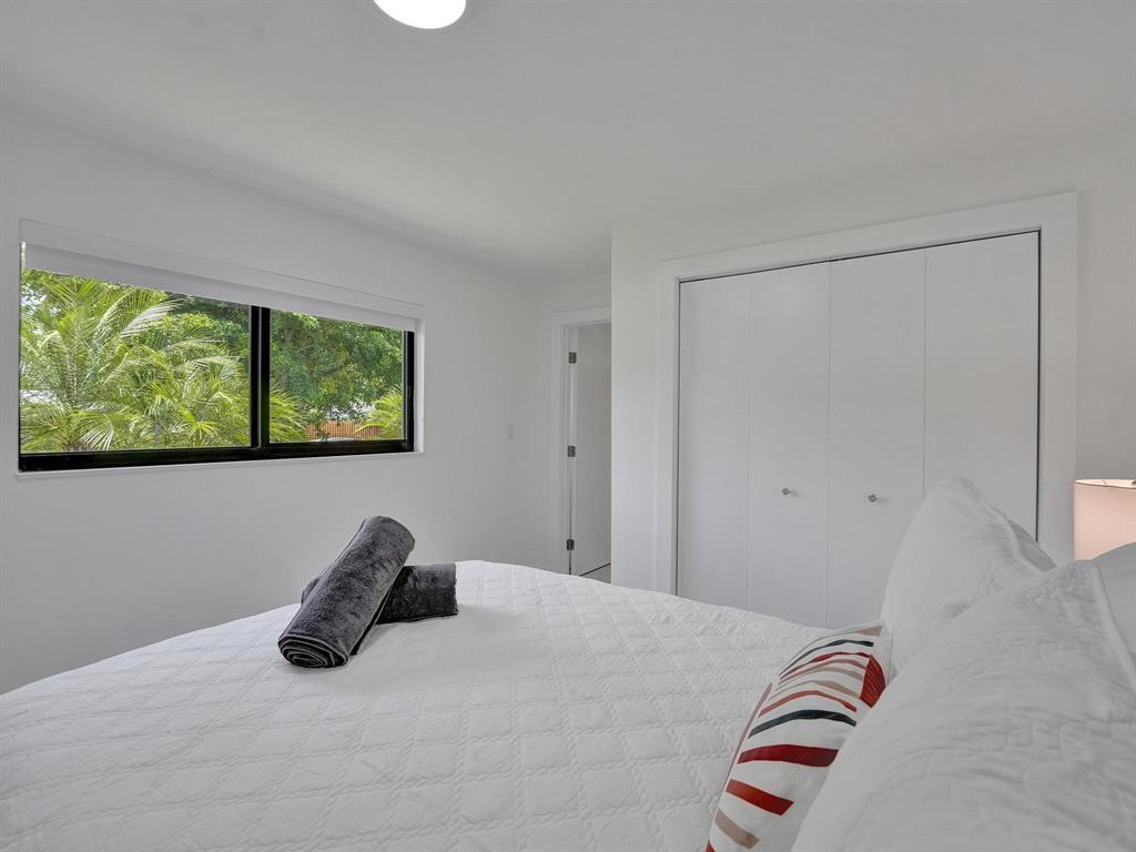 260 Northwest 36th Street Boca Raton, FL 33431 - Photo 14 of 35 a bedroom with a bed and a painting on the wall