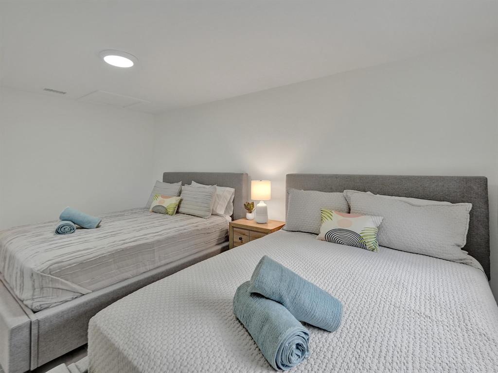 260 Northwest 36th Street Boca Raton, FL 33431 - Photo 21 of 35 a bedroom with a bed and lamp