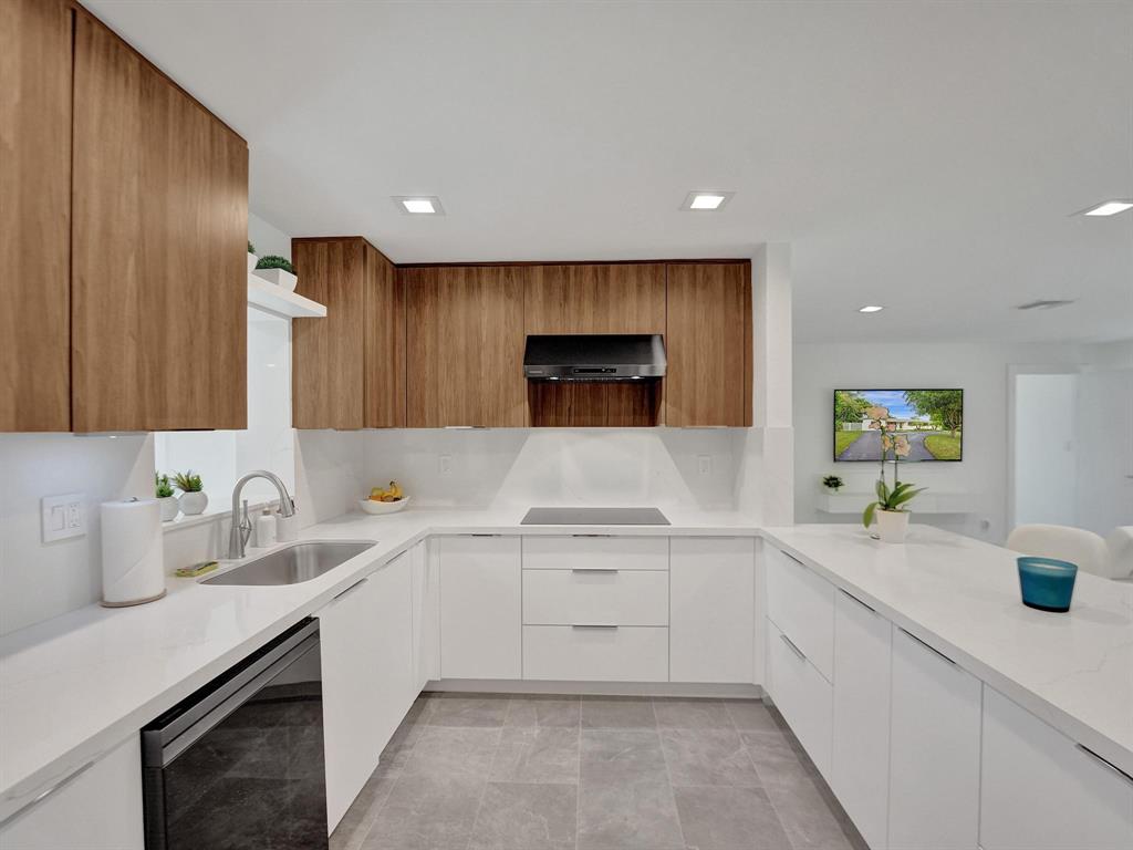 260 Northwest 36th Street Boca Raton, FL 33431 - Photo 29 of 35 a large white kitchen with a sink and dishwasher with white cabinets