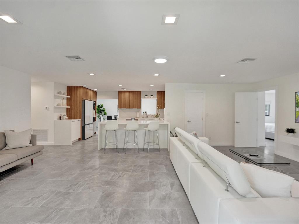 260 Northwest 36th Street Boca Raton, FL 33431 - Photo 33 of 35 a large white building with kitchen island a sink a center island stainless steel appliances and cabinets