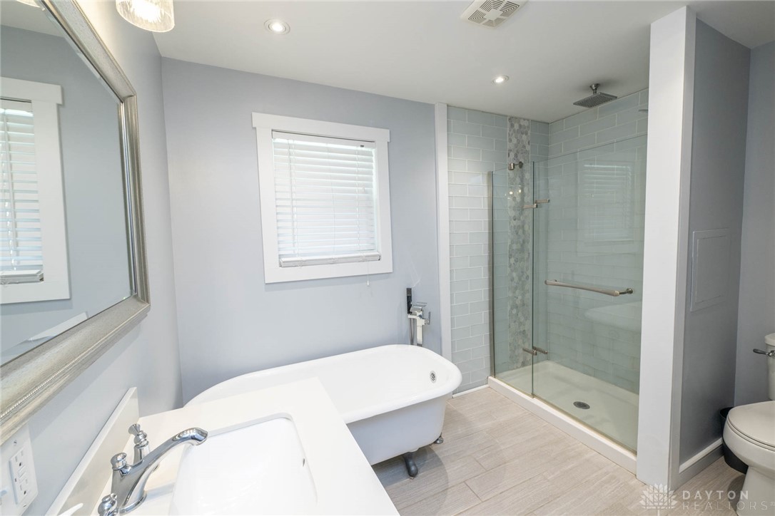 190 Swailes Road Troy, OH 45373 - Photo 18 of 82 This serene bathroom offers a luxurious soaking tub and a spacious glass-enclosed shower.