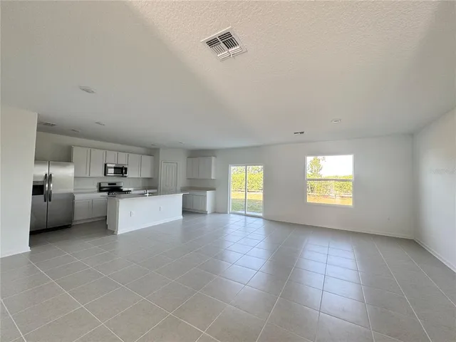 a view of a kitchen with furniture and a window