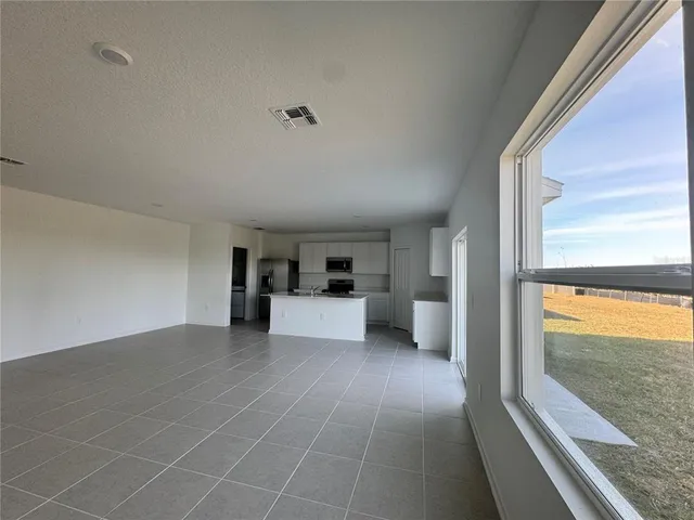 a view of a living room with a large window