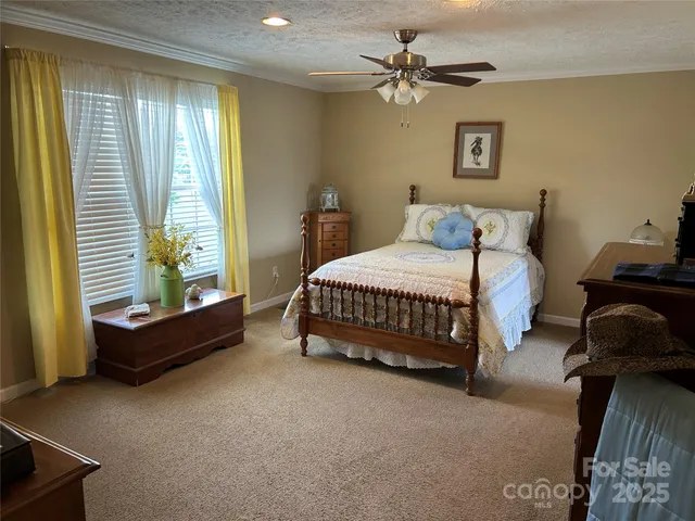 a bedroom with a bed a couch and a window