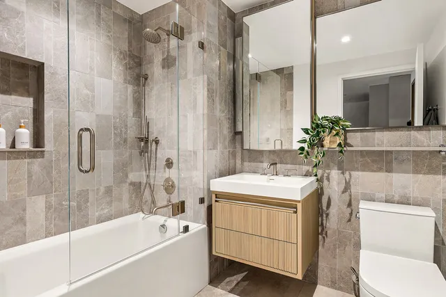 a bedroom with a bed and painting on the wall