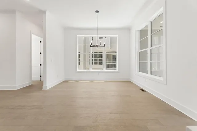 a large kitchen with kitchen island a stove a sink a center island and a window