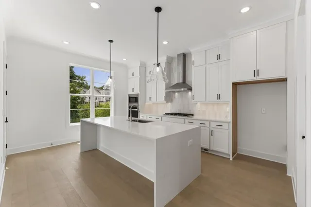 a kitchen with stainless steel appliances granite countertop a sink and window
