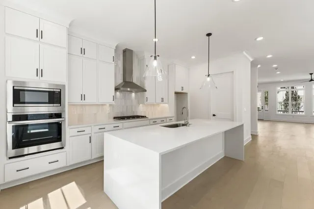 an empty room with windows and fireplace