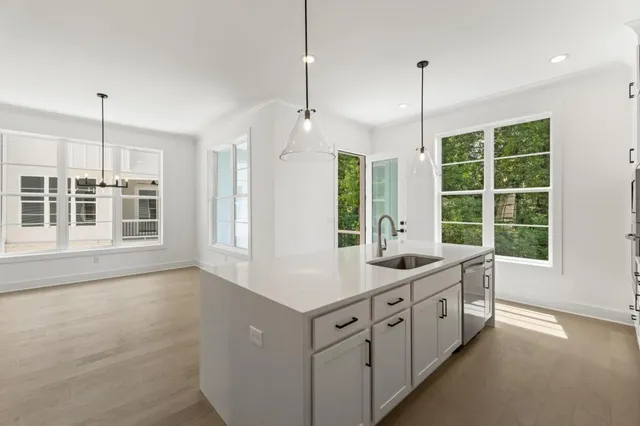 an empty room with closet and windows
