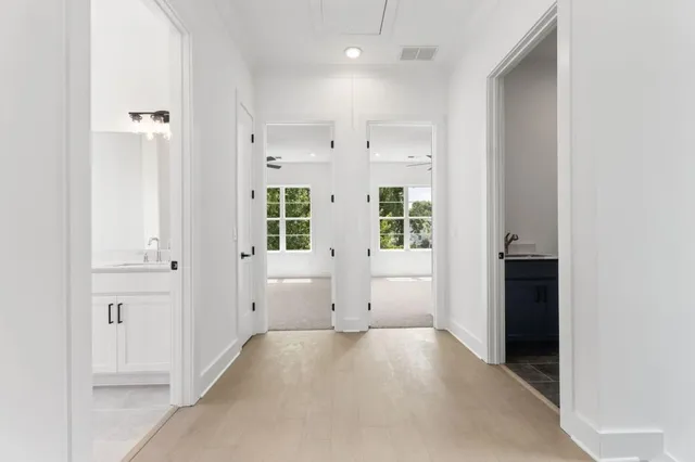 an empty room with cabinet and mirrors