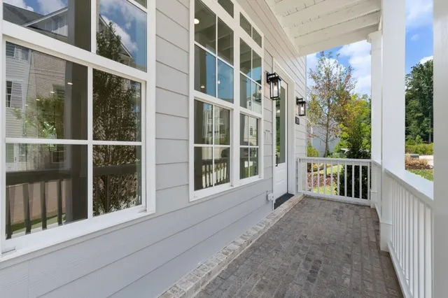 a view of an empty room with a fireplace and a window