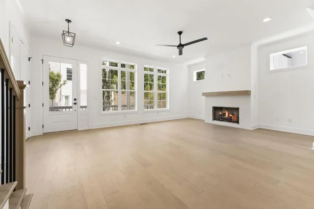a view of an empty room with a fireplace and a window