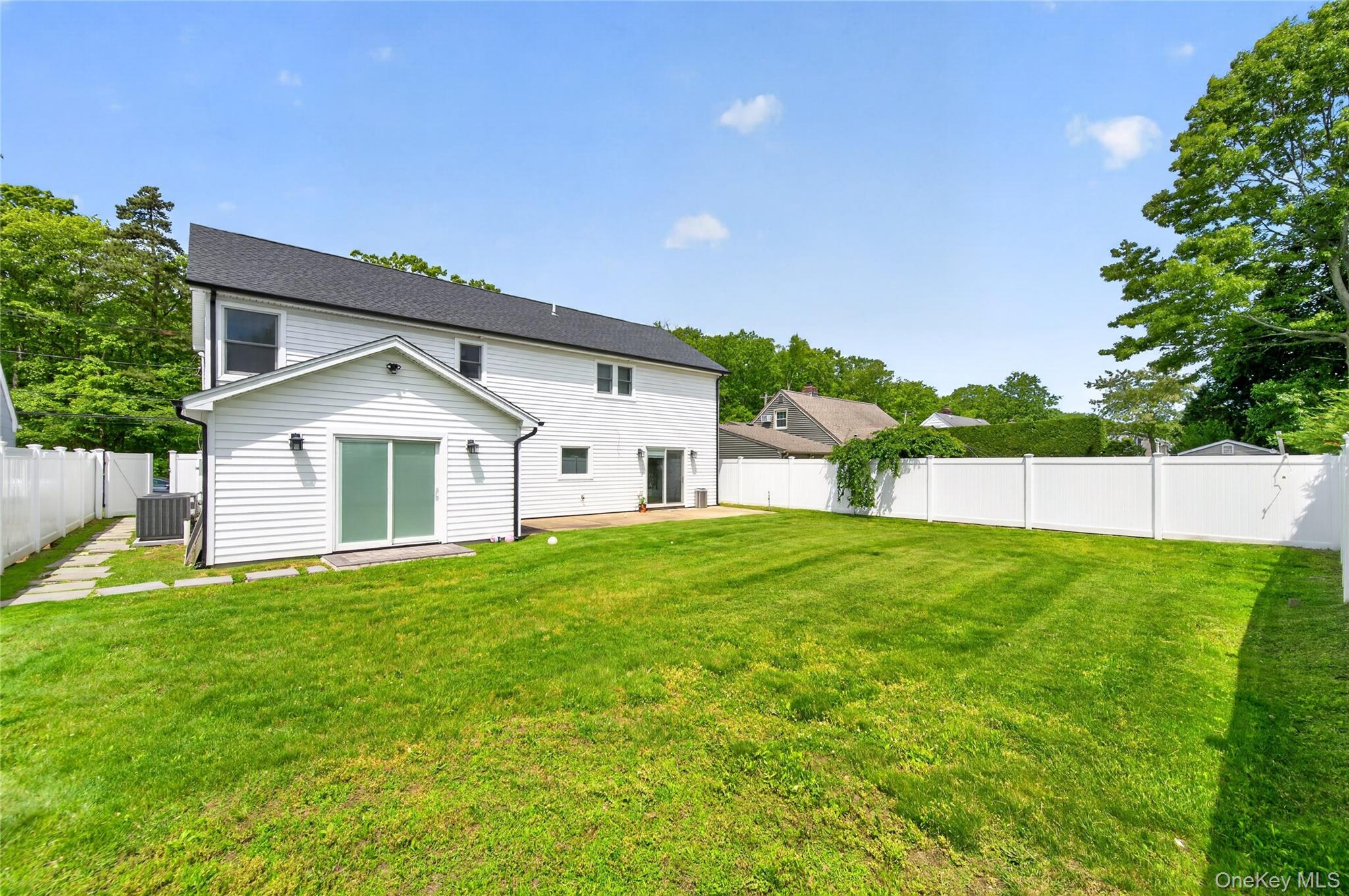 534 Riverside Avenue Massapequa, NY 11758 - Photo 25 of 28 a front view of a house with a yard and trees