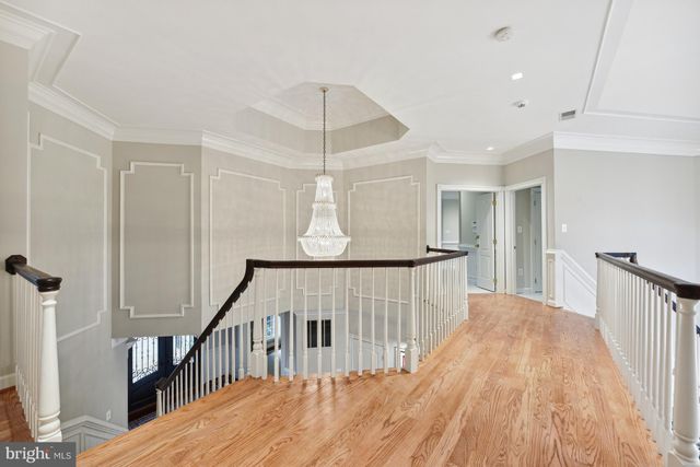 a view of staircase with railing and white walls