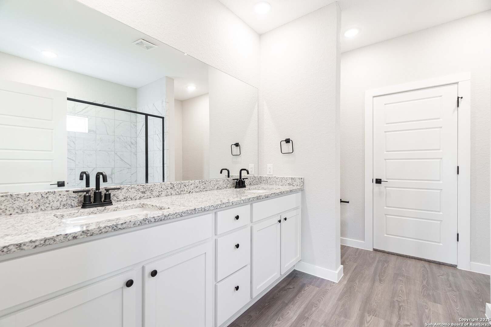 5815 Tree View Street San Antonio, TX 78220 - Photo 12 of 29 a bathroom with a granite countertop sink and a mirror