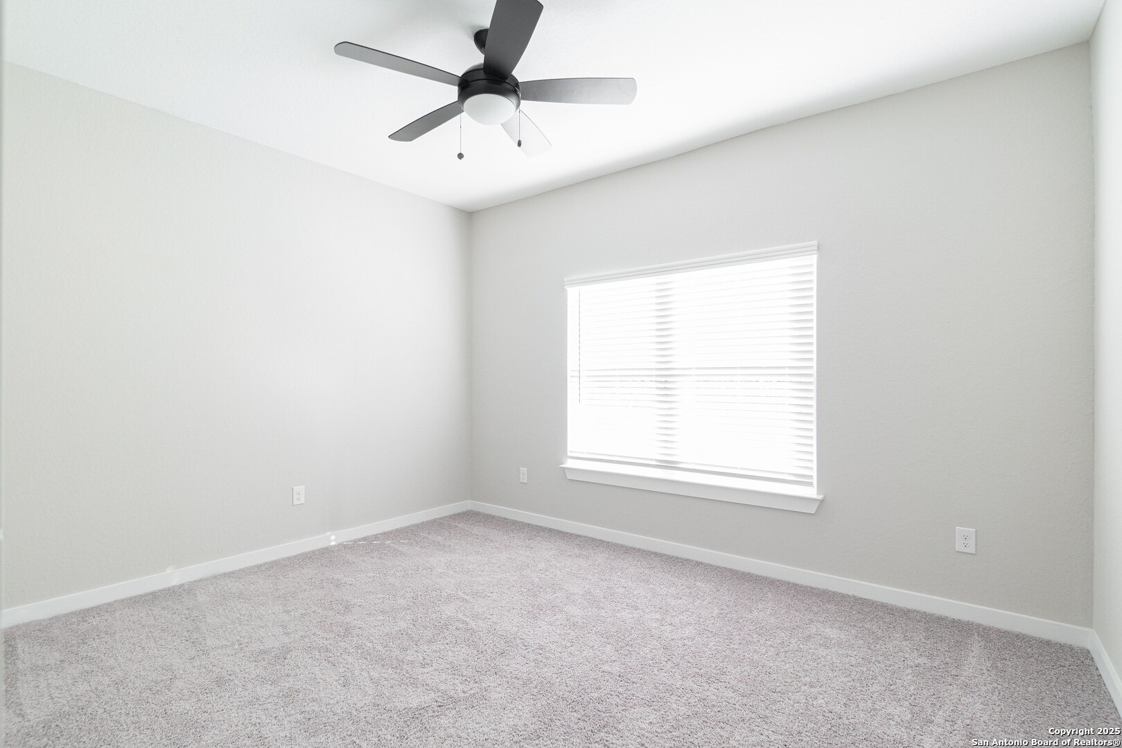 5815 Tree View Street San Antonio, TX 78220 - Photo 17 of 29 an empty room with a window and a fan