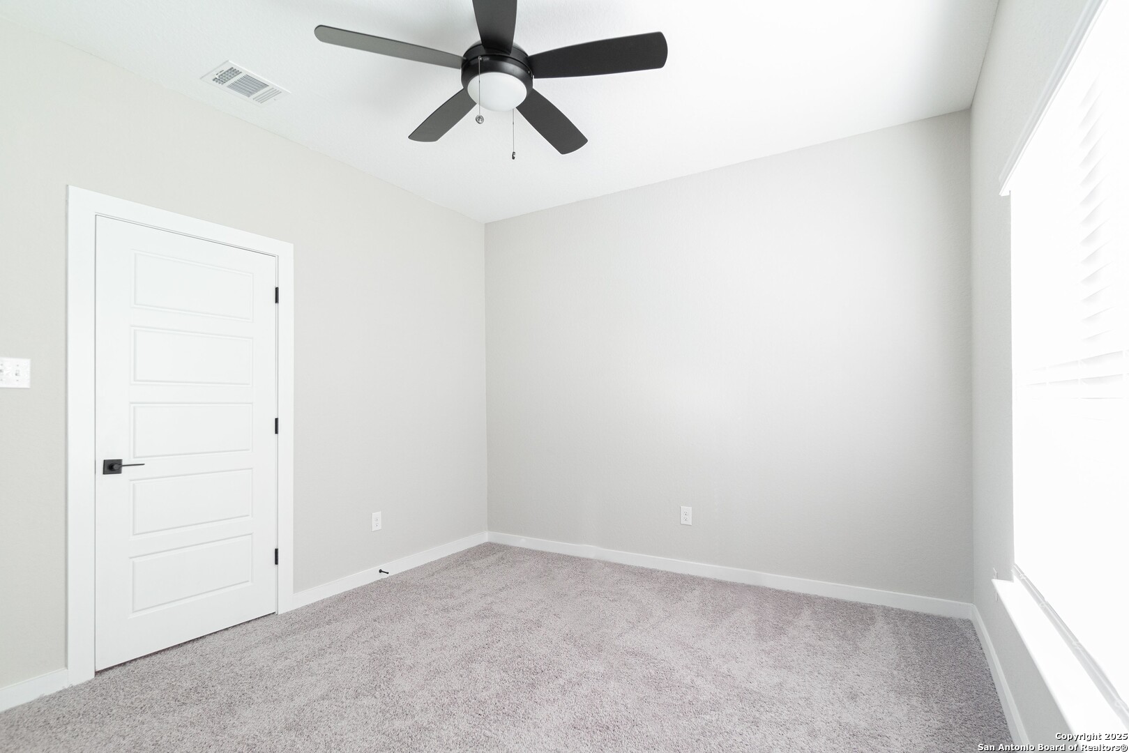 5815 Tree View Street San Antonio, TX 78220 - Photo 18 of 29 an empty room with a window and a fan