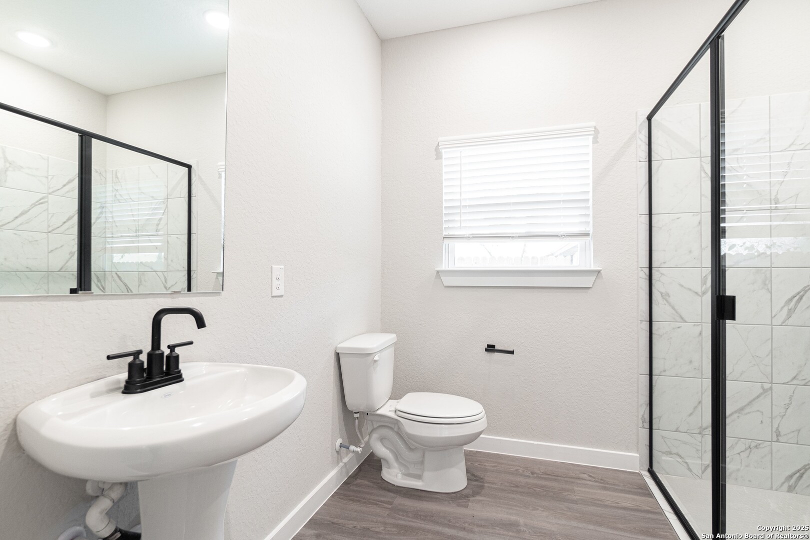 5815 Tree View Street San Antonio, TX 78220 - Photo 19 of 29 a bathroom with a toilet sink and mirror