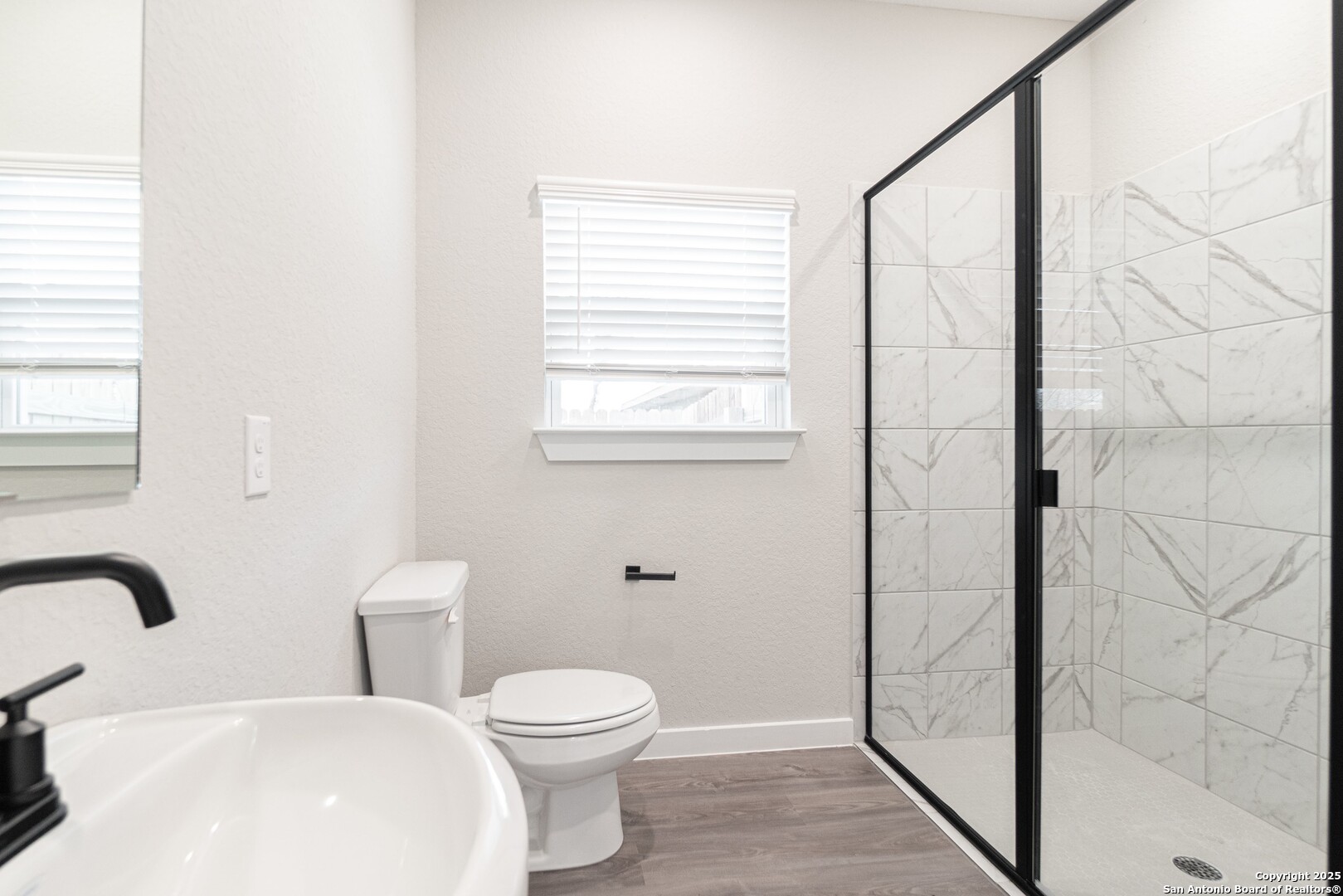 5815 Tree View Street San Antonio, TX 78220 - Photo 20 of 29 a bathroom with a toilet a sink and shower