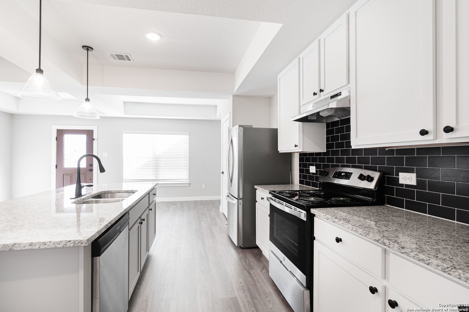 5815 Tree View Street San Antonio, TX 78220 - Photo 7 of 29 a kitchen with stainless steel appliances granite countertop a sink stove and refrigerator