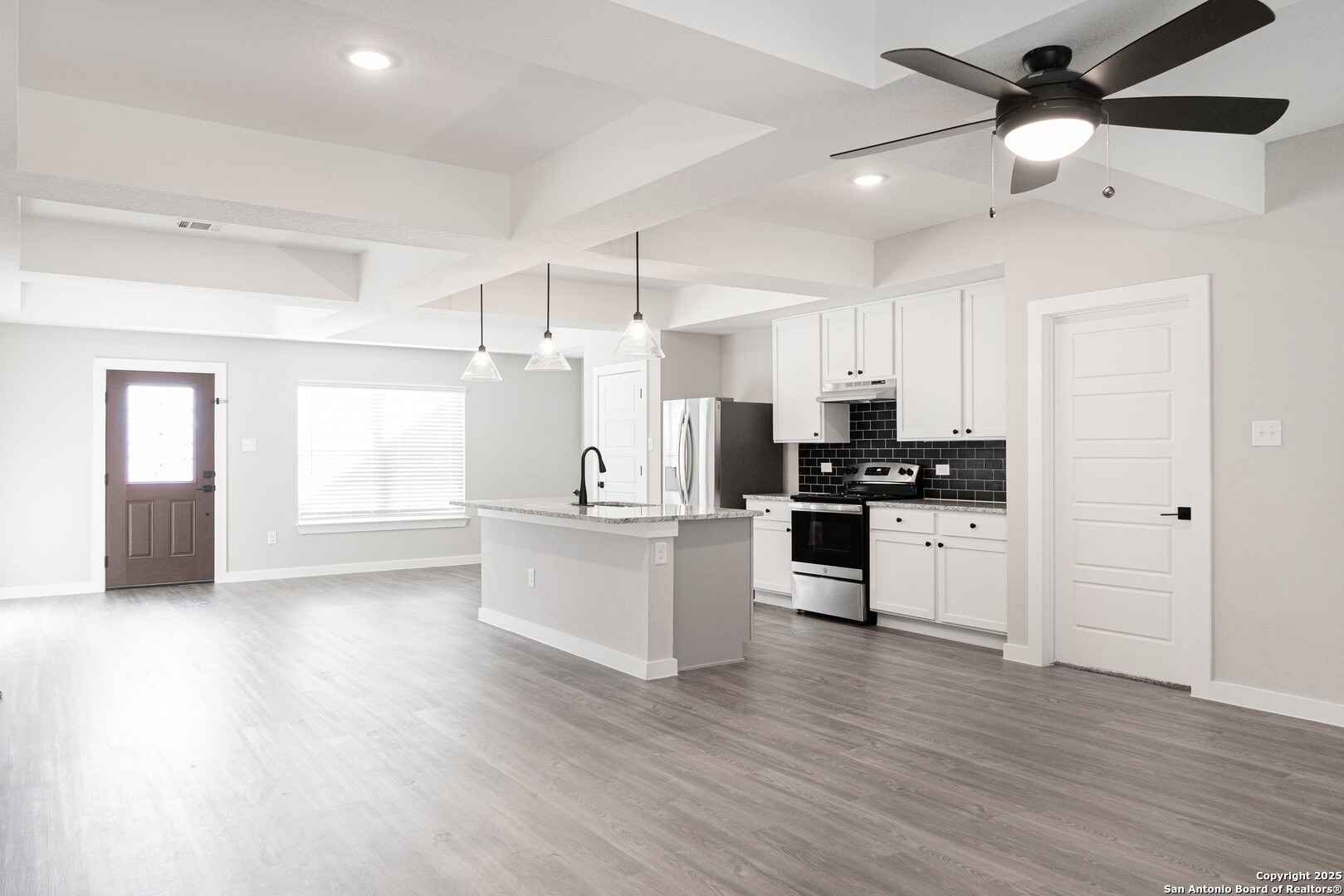 5815 Tree View Street San Antonio, TX 78220 - Photo 9 of 29 a kitchen with a refrigerator and white cabinets