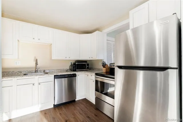 a kitchen with stainless steel appliances a refrigerator sink and cabinets