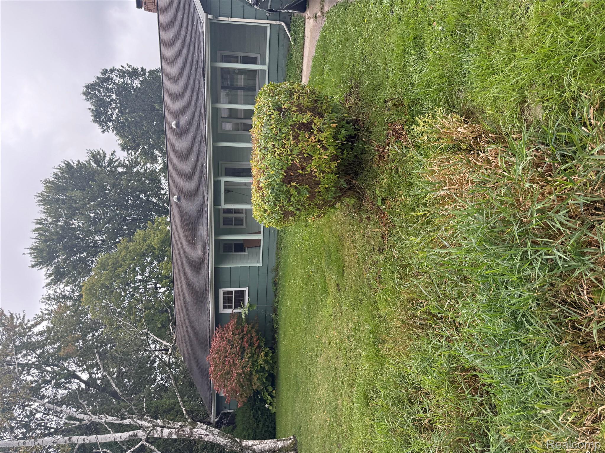3176 East Fisher Road Bay City, MI 48706 - Photo 2 of 25 View of front facade with a front lawn and a chimney