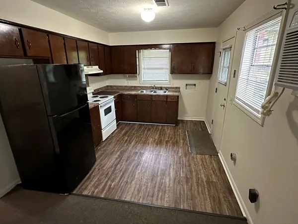 a kitchen with a refrigerator stove and sink