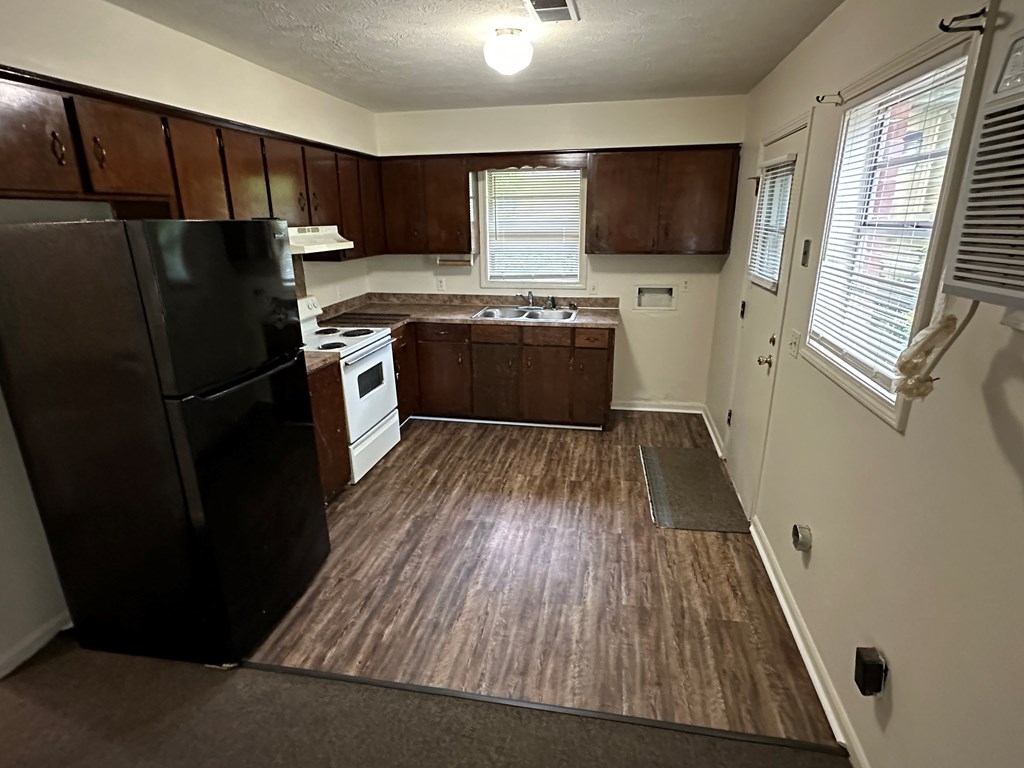 1402 16th Street Columbus, GA 31901 - Photo 3 of 7 a kitchen with a refrigerator stove and sink