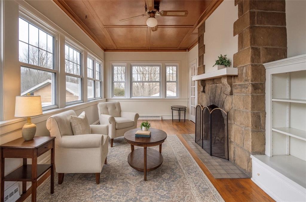 343 East 11th Avenue Tarentum, PA 15084 - Photo 13 of 41 a living room with furniture a fireplace and a floor to ceiling window
