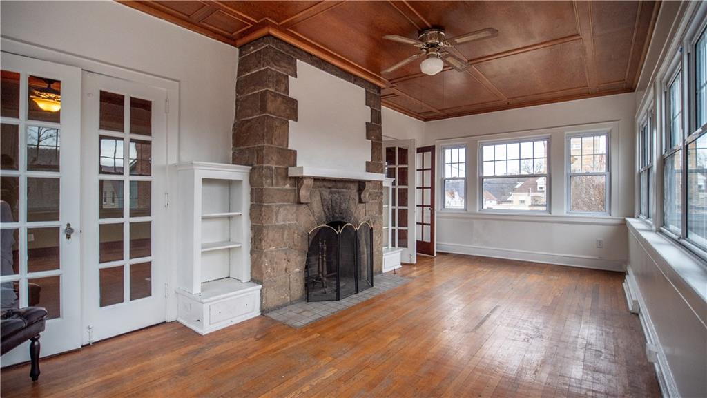 343 East 11th Avenue Tarentum, PA 15084 - Photo 15 of 41 a view of a livingroom with wooden floor a ceiling fan and windows
